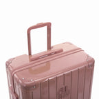 GYL telescopic trolley handle deployed on the Intemporelle rose gold polycarbonate suitcase. #color_rose gold
