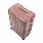 Angled view of the GYL Intemporelle rose gold hard suitcase with reinforced corners and shiny ribbed shell. #color_rose gold