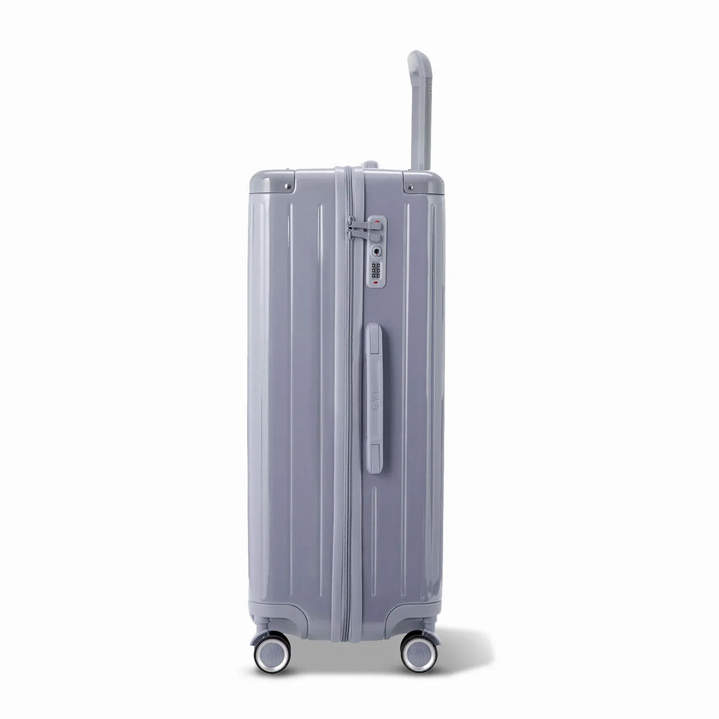Side view of the GYL Intemporelle silver hard suitcase with telescopic handle and TSA closure. #silver_color
