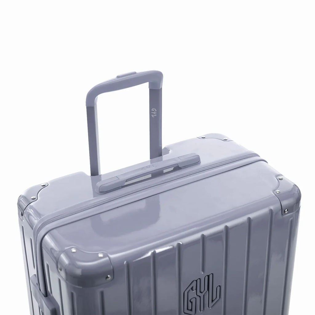 GYL telescopic trolley handle deployed on the Intemporelle silver polycarbonate suitcase. #silver_color