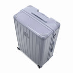 Angled view of the silver GYL Intemporelle hardshell suitcase with reinforced corners and shiny ribbed shell. #silver_color