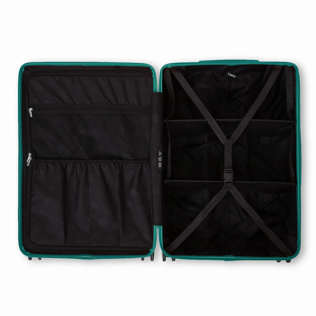 Compartmented interior of the water green GYL Intemporelle suitcase with crossed straps and mesh pockets. #color_green