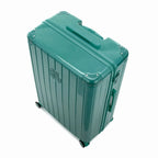 Angled view of the water green GYL Intemporelle hardshell suitcase with reinforced corners and shiny ribbed shell. #color_green