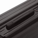 Rigid top handle of the black GYL Intemporelle suitcase with embossed logo on the top. #black_color