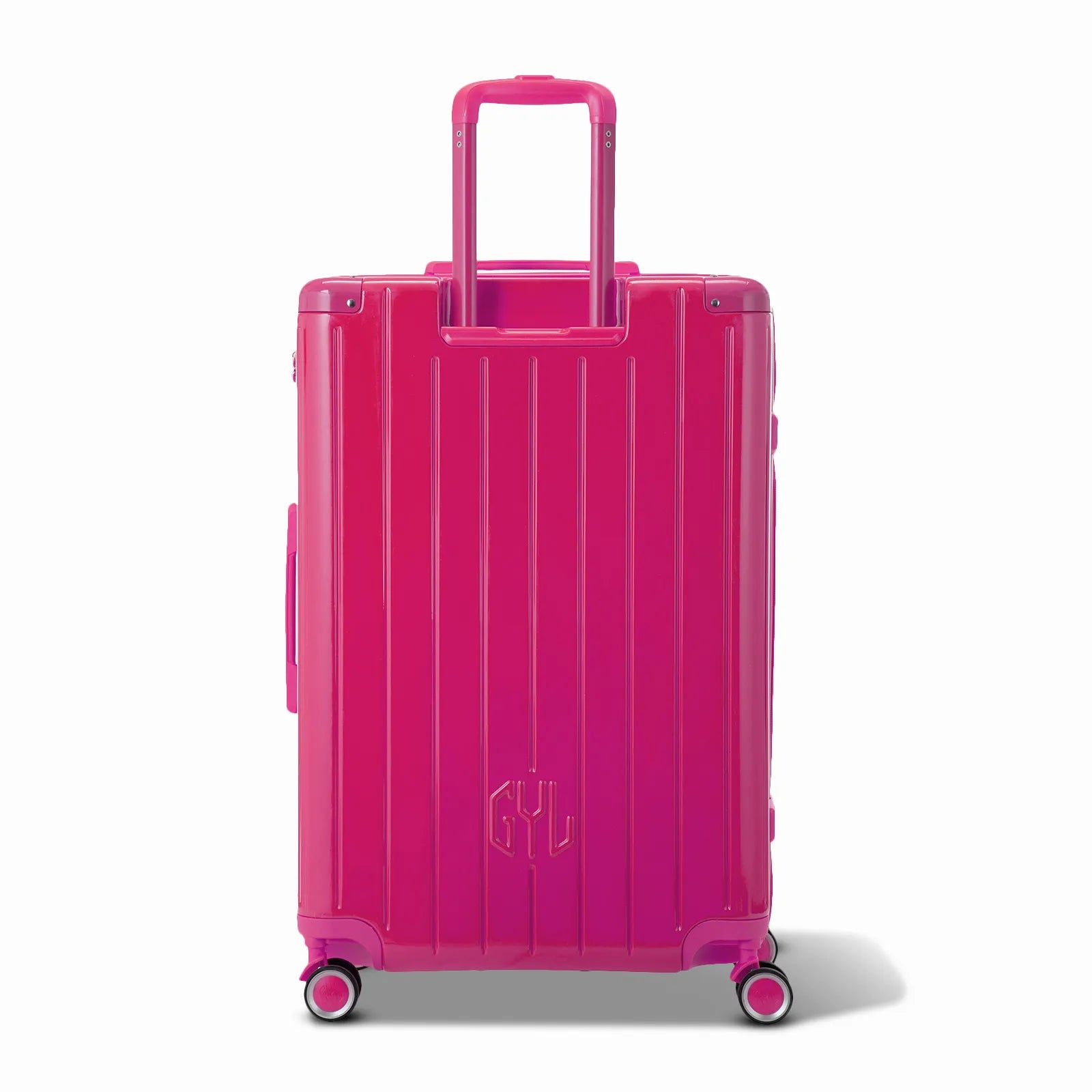 Vista trasera de la maleta rígida GYL Intemporelle fucsia con asas integradas y ruedas giratorias. #couleur_fuchsia