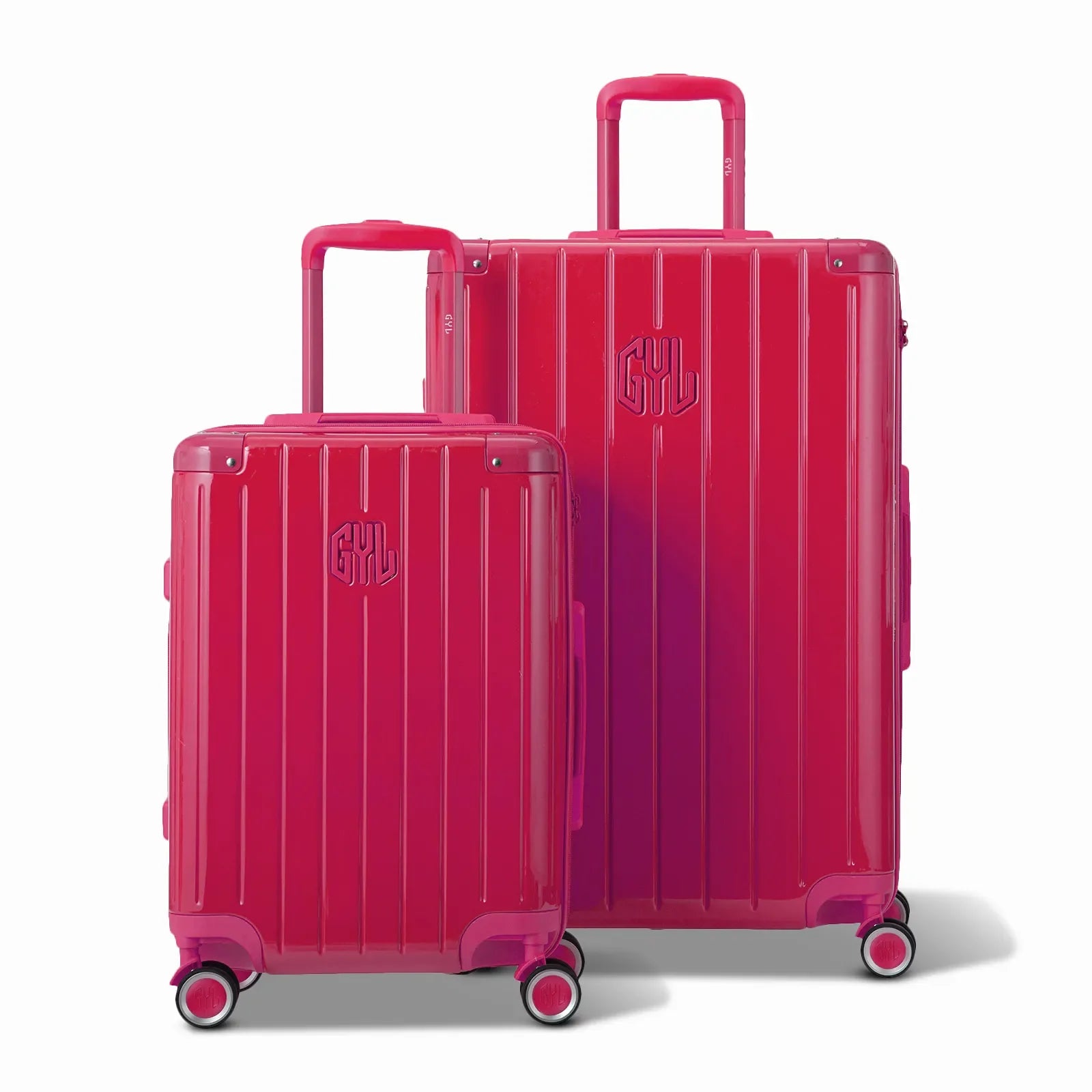 Two GYL Intemporelle fuchsia rigid suitcases, cabin and hold format, with extended trolley handle. #color_fuchsia