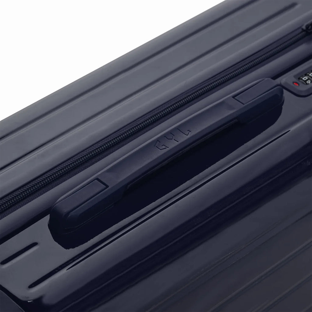 Rigid top handle of the GYL Intemporelle navy suitcase with embossed logo on the top. #navy_color