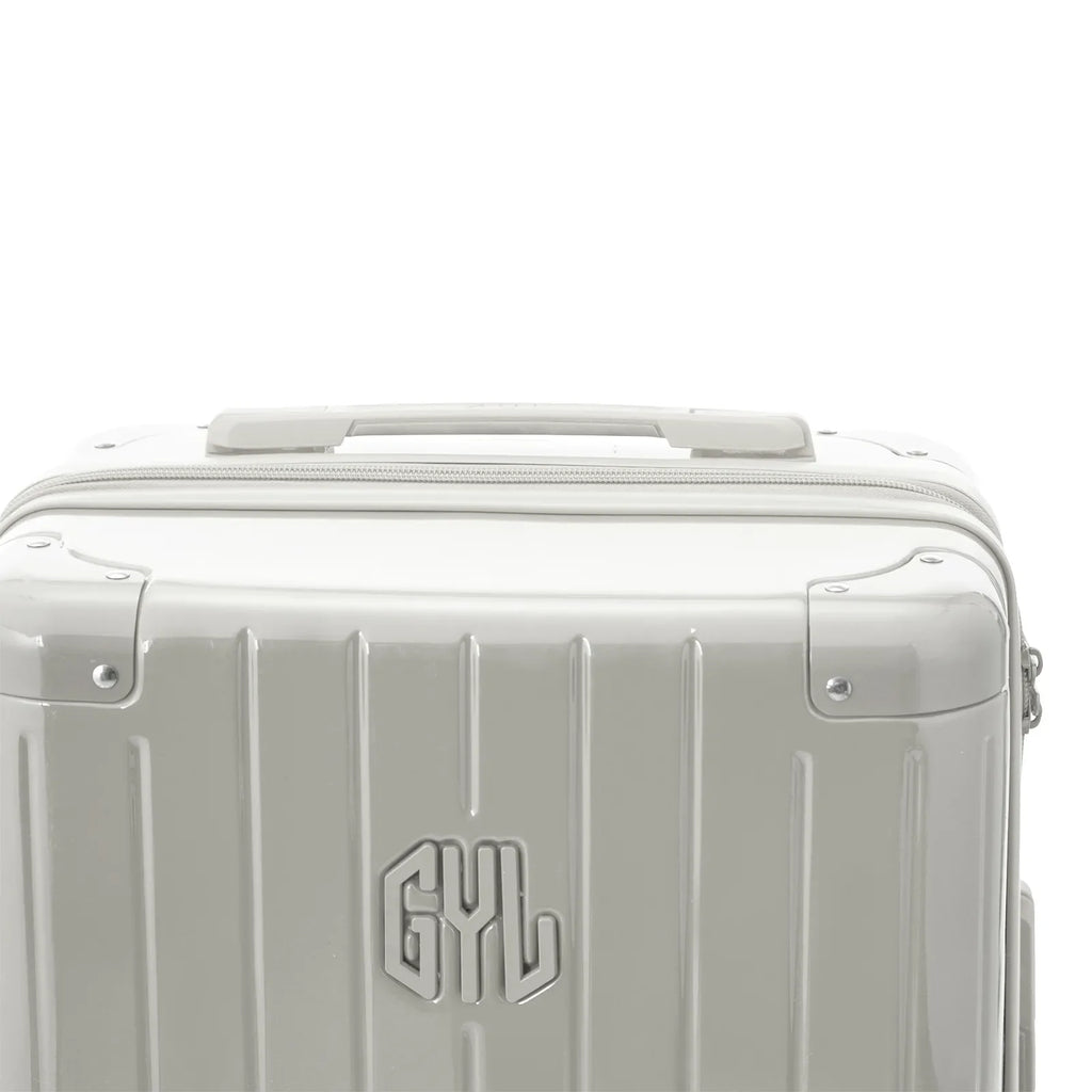 Rigid top handle of the GYL Intemporelle sand suitcase with embossed logo on the top. #sand_color