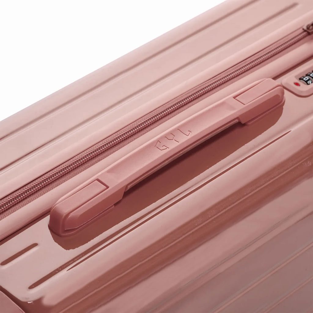 Rigid top handle of the GYL Intemporelle rose gold suitcase with embossed logo on the top. #color_rose gold