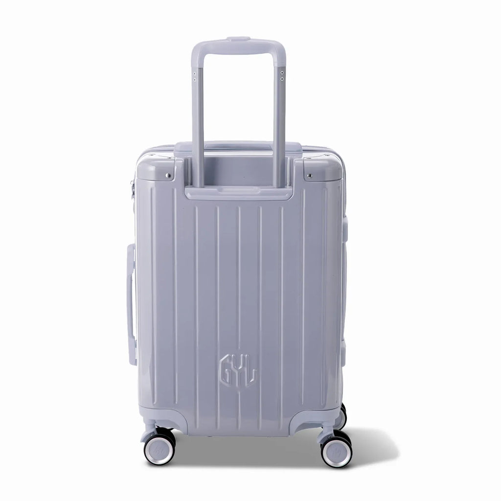 Rear view of the GYL Intemporelle silver hard suitcase with integrated handles and swivel casters. #silver_color