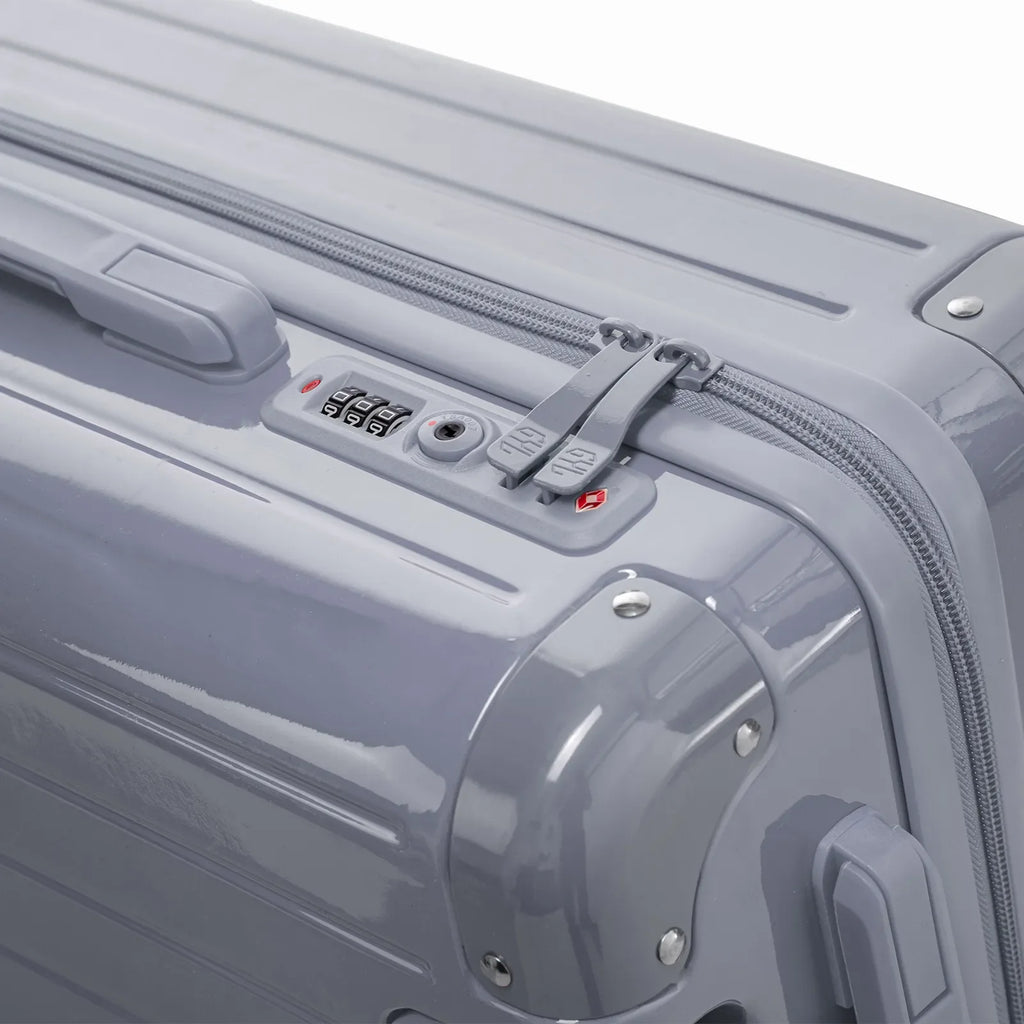 TSA combination closure and GYL double zip slider on the Intemporelle silver hard suitcase. #silver_color