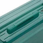 Rigid top handle of the water green GYL Intemporelle suitcase with embossed logo on the top. #color_green