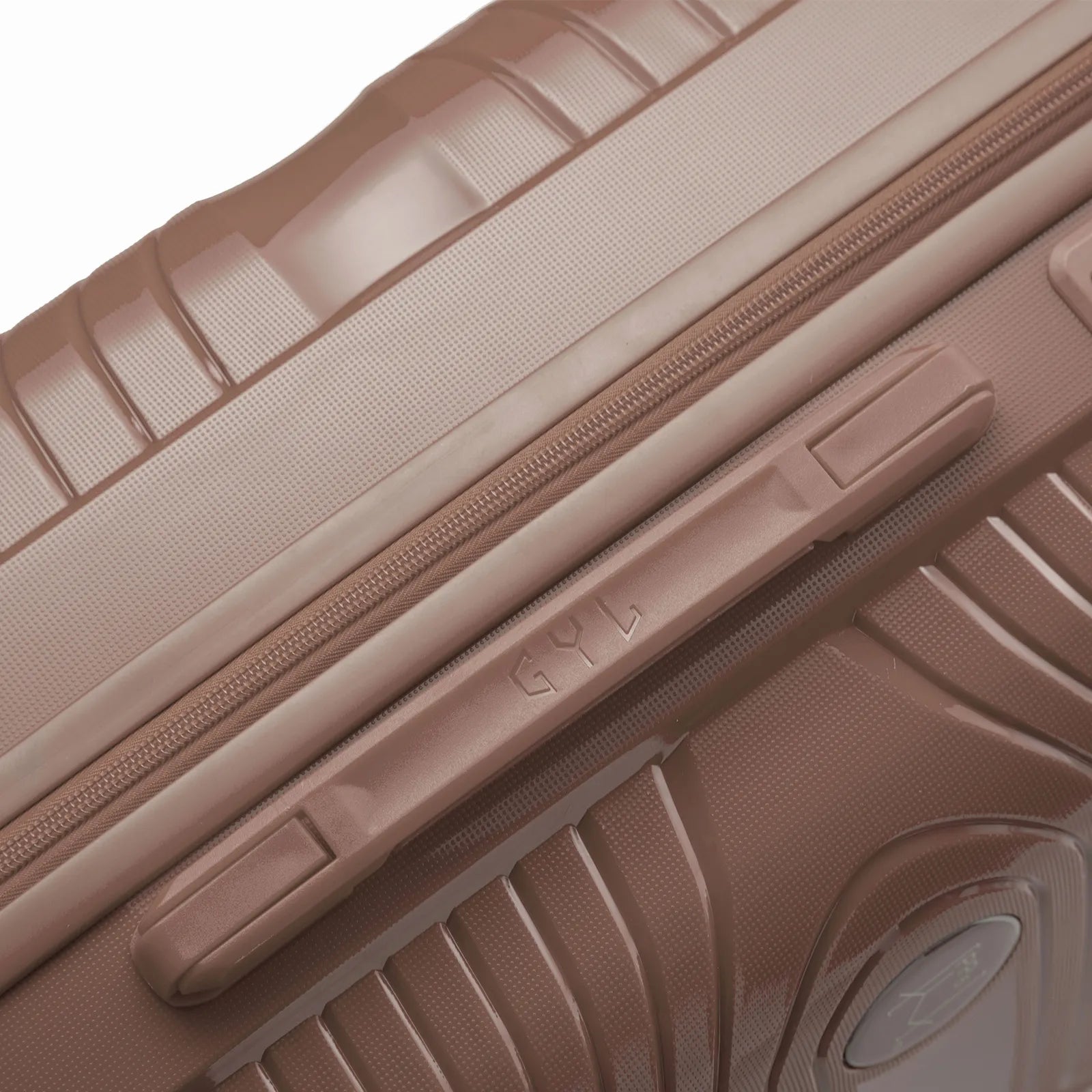 Détail de la poignée latérale et du logo GYL sur la valise Signature champagne. #couleur_champagne