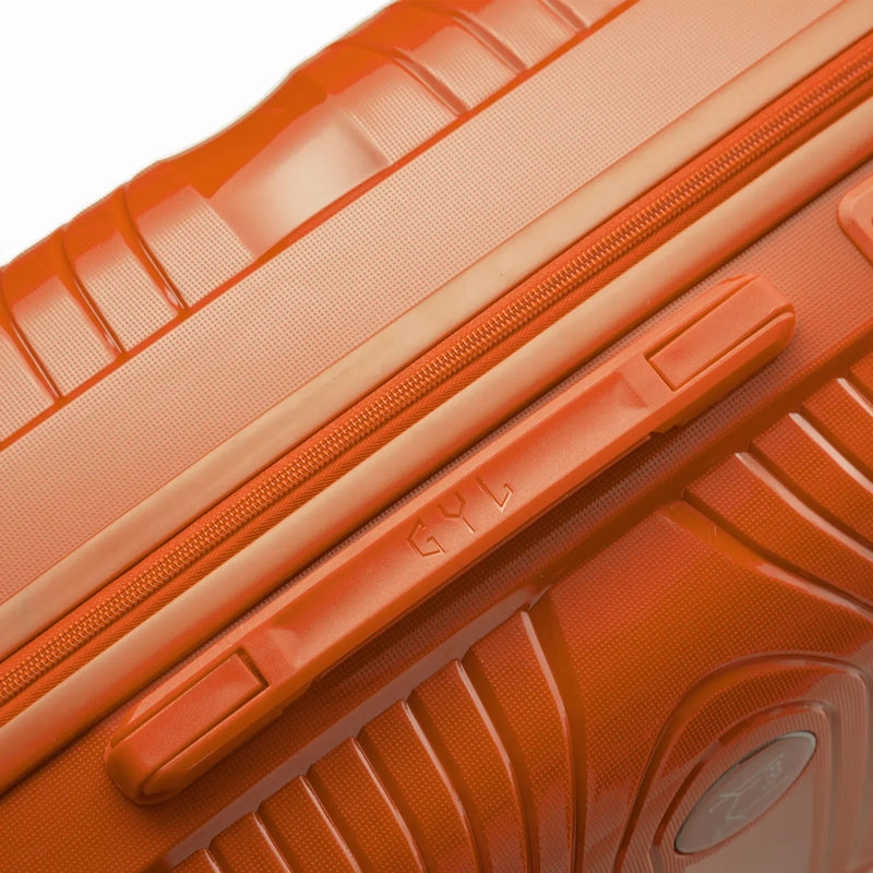 Detail of the side handle and the GYL logo on the orange Signature suitcase. #color_orange