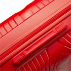 Détail de la poignée latérale et du logo GYL sur la valise Signature rouge. #couleur_rouge