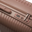 Detail of the integrated TSA lock and sliders on the Signature champagne suitcase. #color_champagne
