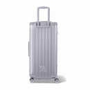 Dos de la valise trunk GYL XL argent avec trolley télescopique sorti et logo embossé. #couleur_argent