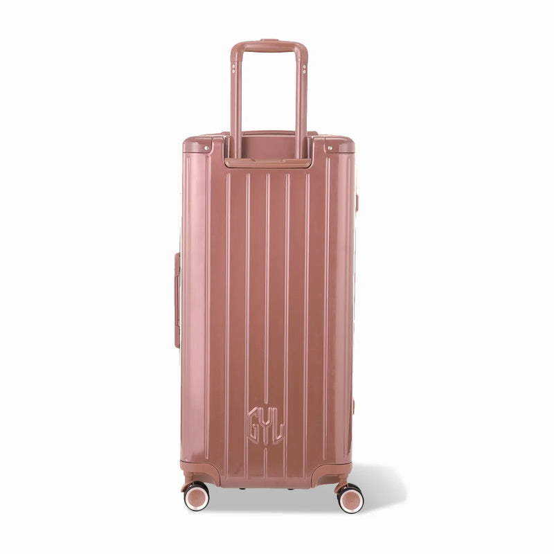 Dos de la valise trunk GYL XL rose gold avec trolley télescopique sorti et logo embossé. #couleur_rose gold