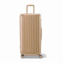 Maleta baúl GYL tamaño XL en policarbonato champagne, vista frontal, con carro desplegado y ruedas de 360°.  #color_champán