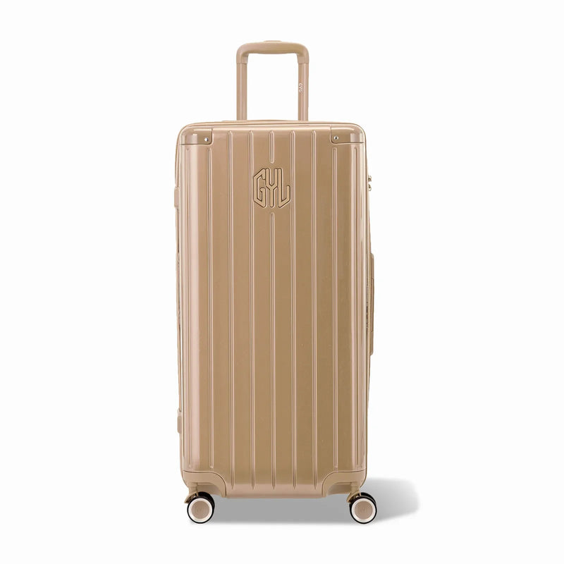 Maleta baúl GYL tamaño XL en policarbonato champagne, vista frontal, con carro desplegado y ruedas de 360°.  #color_champán