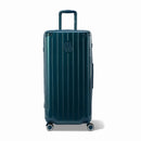 Maleta baúl GYL tamaño XL en policarbonato de abeto, vista frontal, con carro desplegado y ruedas de 360°.  #color_abeto