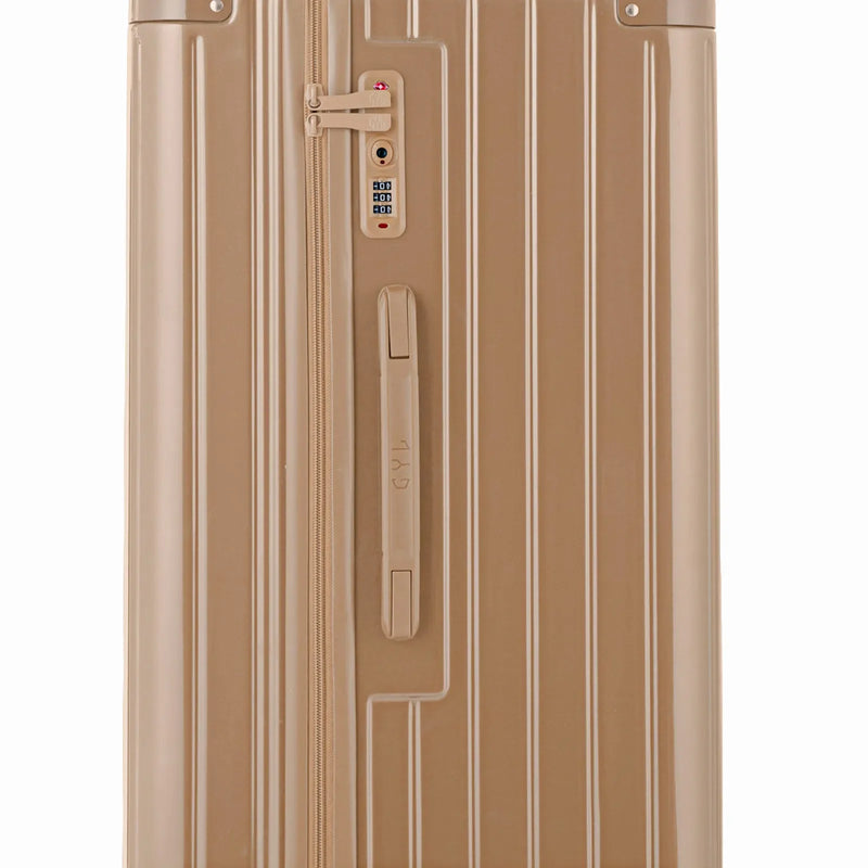 Detalle de la cerradura TSA y del asa lateral de la maleta baúl champagne. #color_champán