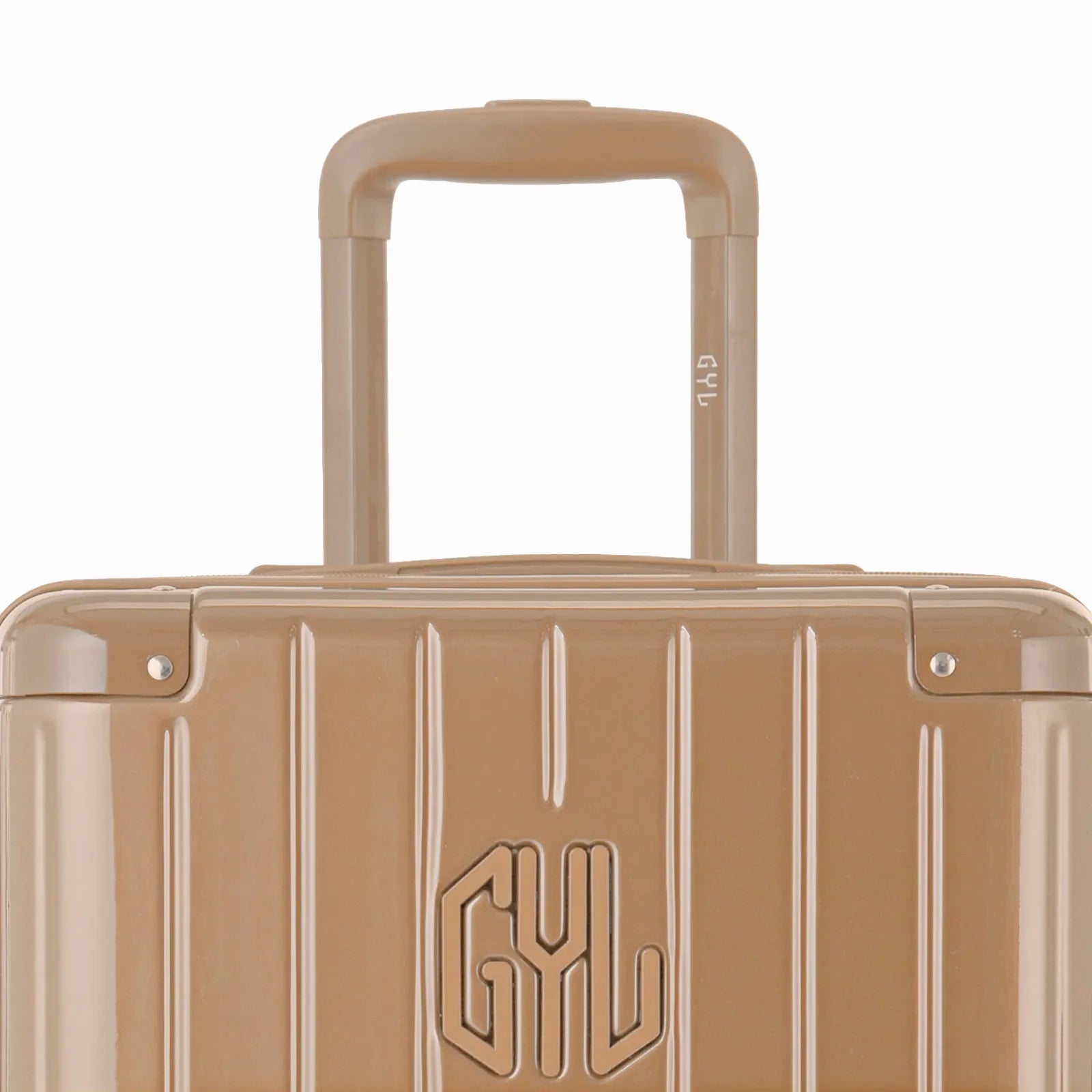 Zoom sur la poignée trolley et le logo GYL de la valise trunk champagne. #couleur_champagne