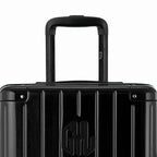 Zoom sur la poignée trolley et le logo GYL de la valise trunk noir. #couleur_noir