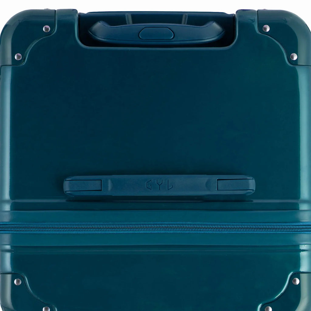 Vue du dessus de la valise trunk GYL sapin en polycarbonate, avec poignée centrale et coins renforcés. #couleur_sapin