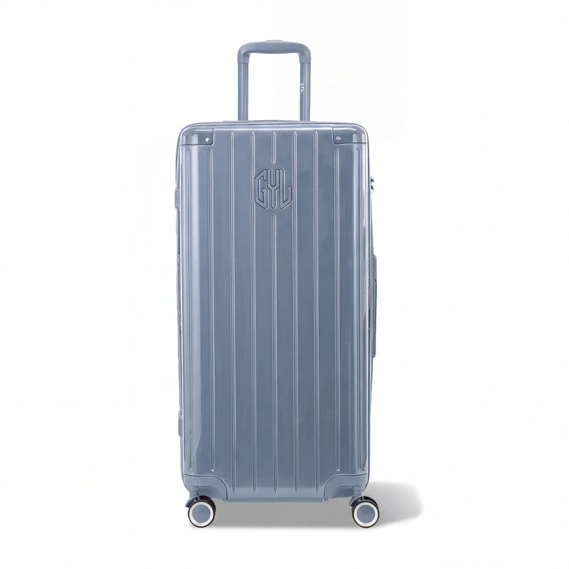 Valise trunk GYL taille XL en polycarbonate bleu gris vue de face, avec trolley déployé et roues 360°.  #couleur_bleu grisé