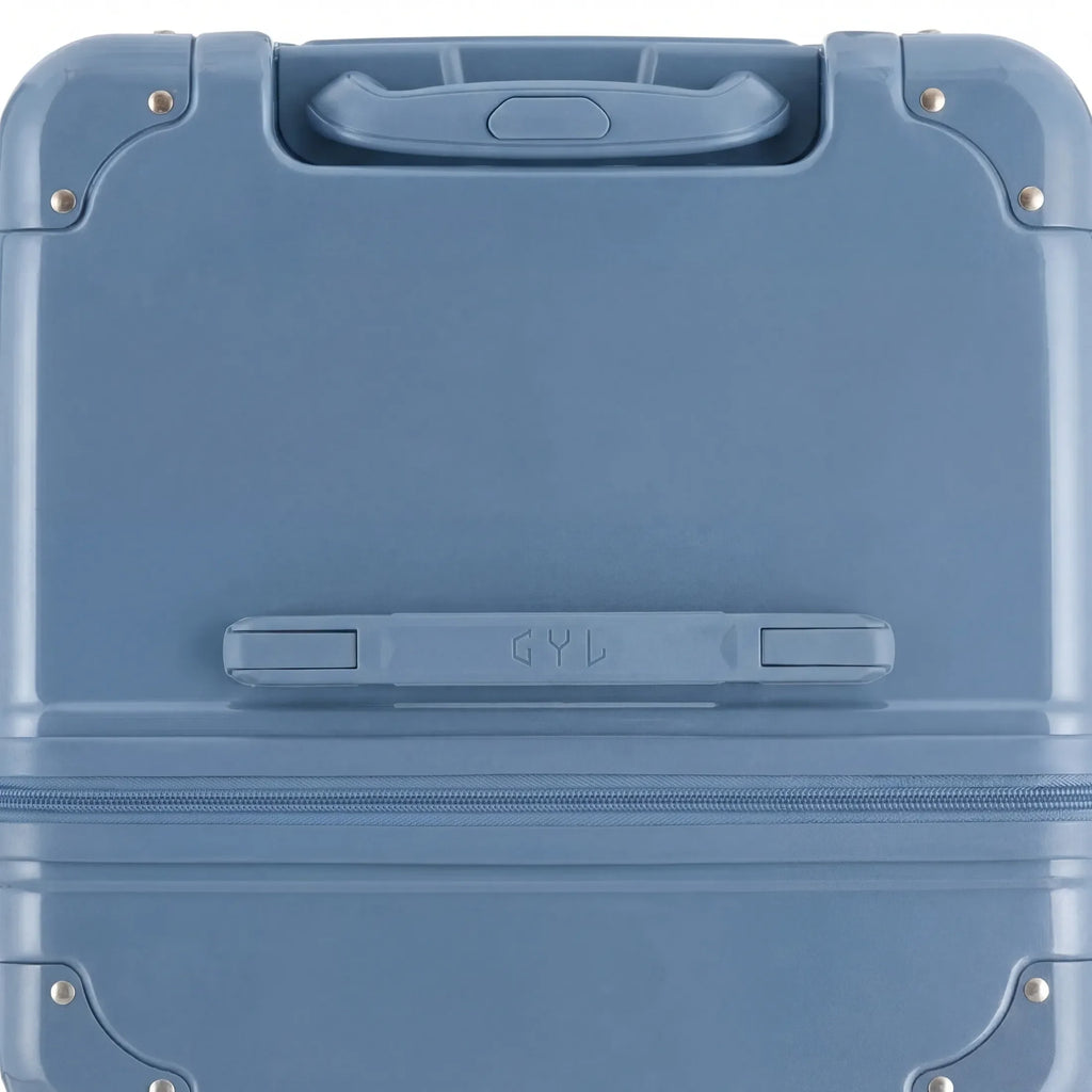 Vue du dessus de la valise trunk GYL bleu gris en polycarbonate, avec poignée centrale et coins renforcés. #couleur_bleu grisé