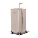 Valise trunk GYL taille XL en polycarbonate nude vue de trois quarts, avec trolley déployé et roues 360°. #couleur_nude