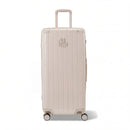 Maleta baúl GYL tamaño XL en policarbonato nude, vista frontal, con carro desplegado y ruedas de 360°.  #color_desnudo