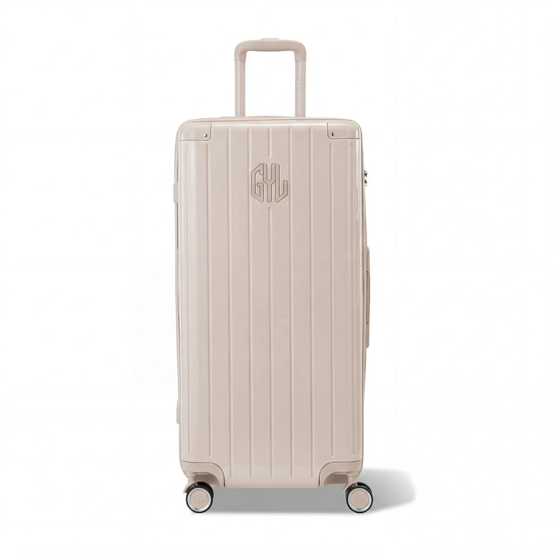 Maleta baúl GYL tamaño XL en policarbonato nude, vista frontal, con carro desplegado y ruedas de 360°.  #color_desnudo