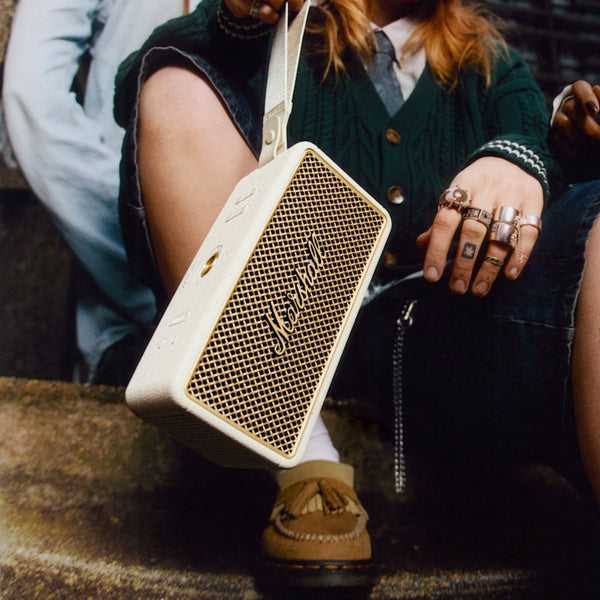 Marshall – Middleton II - Portable Speaker - Cream, cream and gold portable speaker carried by a seated person