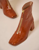 Heeled boots in cognac patent leather