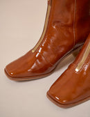 Heeled boots in cognac patent leather