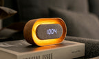 Gingko Design – Lumos Uhr - Oval Weiße Esche, digitaler Wecker aus hellem Holz und grauem Stoff mit Zeitanzeige auf einem Buch