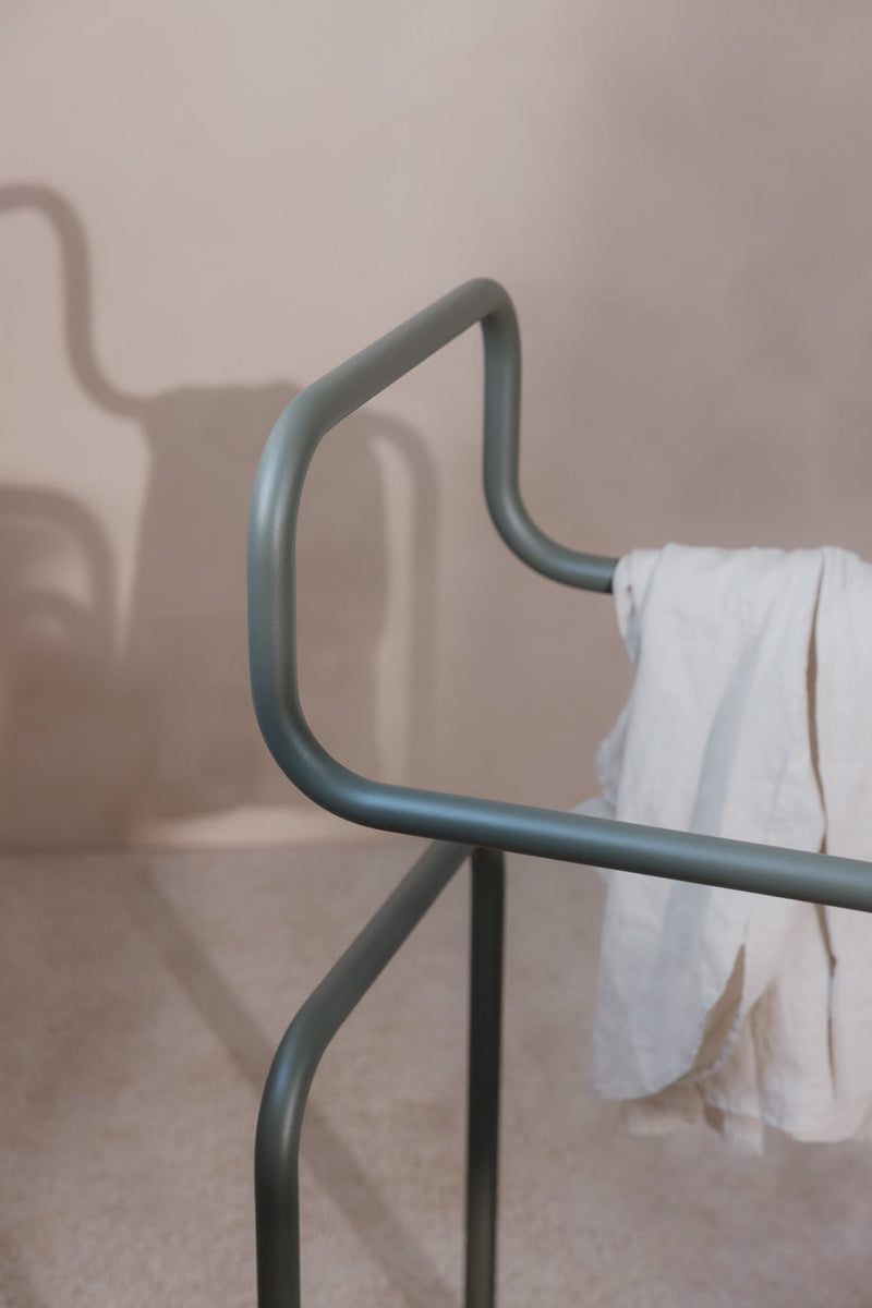 Detailaufnahme des Herrendieners JAMES mit minimalistischer Designstruktur und Kleidung drapiert.
