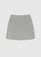 An'ge – Jupe Courte Jyma Ecru, mini-jupe en tweed gris clair avec des ornements brillants, vue de face