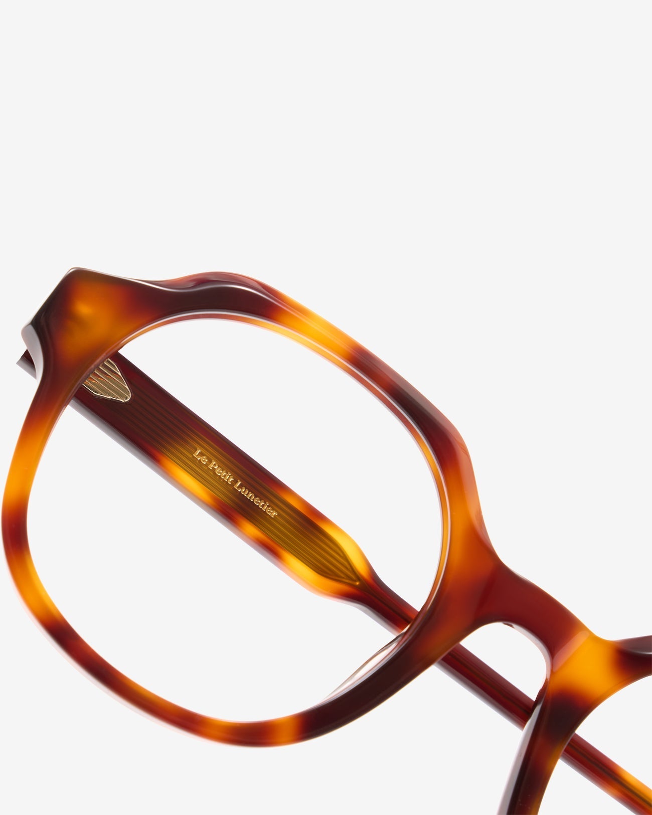 Anteojos Flora Ecaille: montura redonda de acetato, vista de tres cuartos