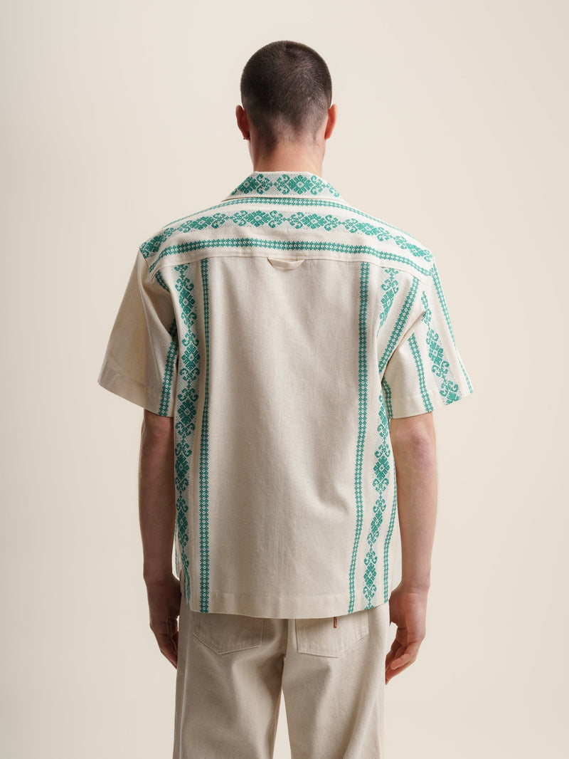 Green folklore short sleeve shirt with intricate patterns and vibrant colors. Perfect for a casual yet stylish look.