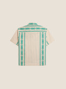 A green folklore short sleeve shirt made from a cotton and linen blend.