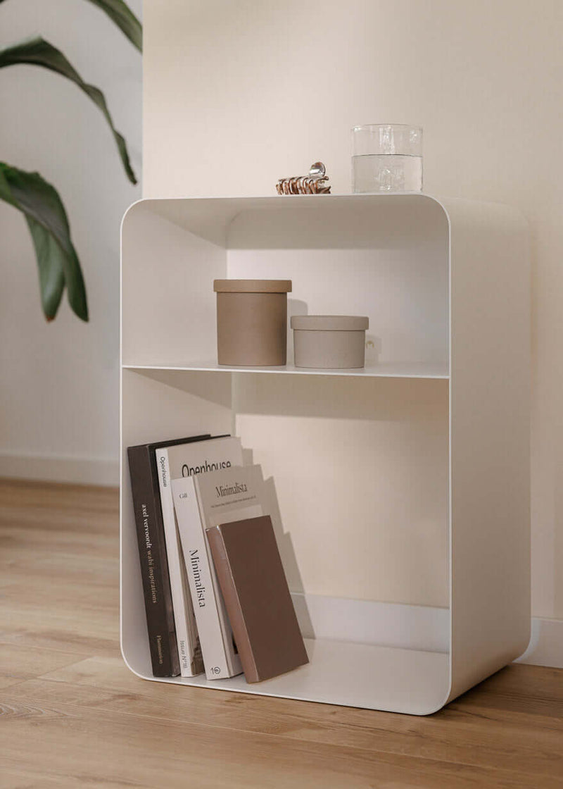 Stehender Nachttisch mit minimalistischen Formen und pulverbeschichteter Oberfläche in einem modernen Raum.