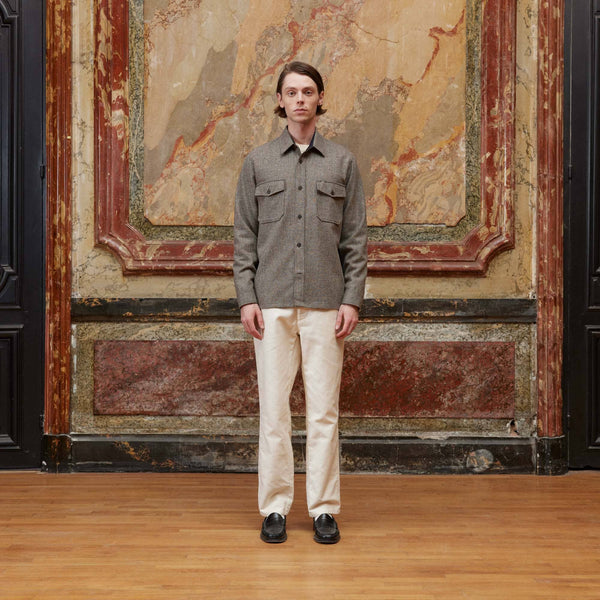 Hast – Brun overshirt i ull med mikrotuppfjätmönster, manlig modell iklädd grå skjorta och vita byxor, framifrån