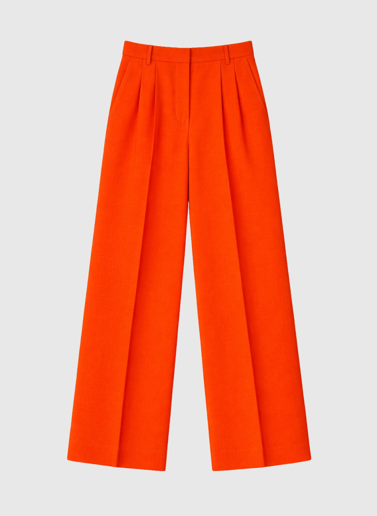An'ge – Hose Pepy Piment, weite Plisseehose in leuchtendem Orange vor hellgrauem Hintergrund