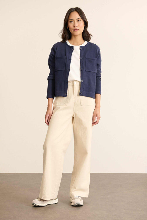 Mannequin de face portant un jean écru en denim 100% coton, coupe droite avec ceinture plate et poches devant.