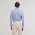 Hast – Blue Two-Ply End-on-End Shirt, blue shirt worn by a model seen from behind, beige trousers