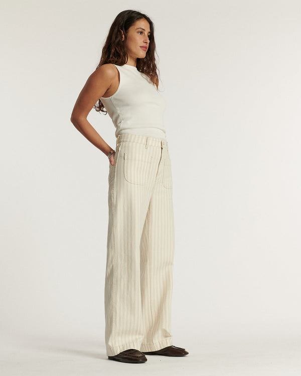 Women's jeans in light sand-colored cotton with fine stripes, wide and loose cut, offering summer comfort and a relaxed silhouette adaptable to all body shapes.