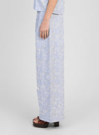 An'ge – Pantalon Ralya Rayure, pantalon large bleu ciel brodé de fleurs blanches, porté de profil